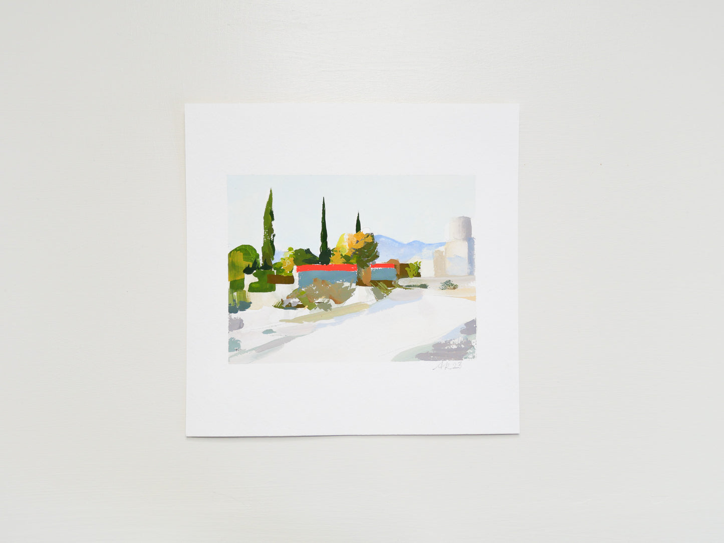 Bright modern desert landscape with trees, buildings, and bold color. Red-lidded dumpsters create bold geometric graphic shapes in the composition.