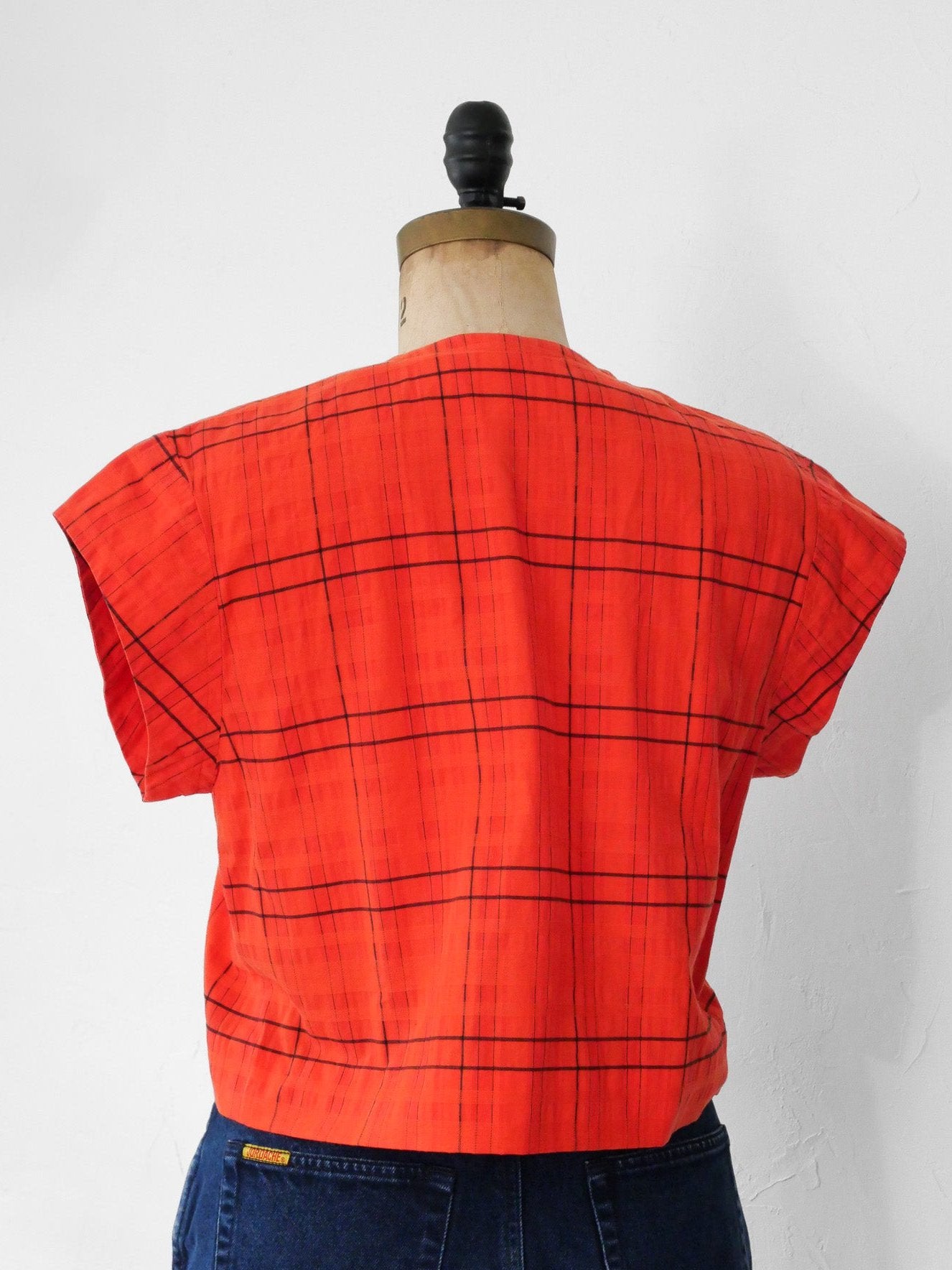 Back of red orange upcycled crop top on dress form